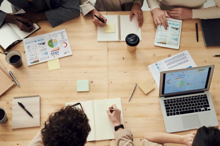 People sitting around a desk having a team meeting