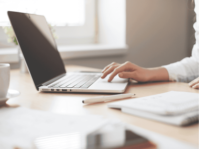 Laptop on table with hand writing on it