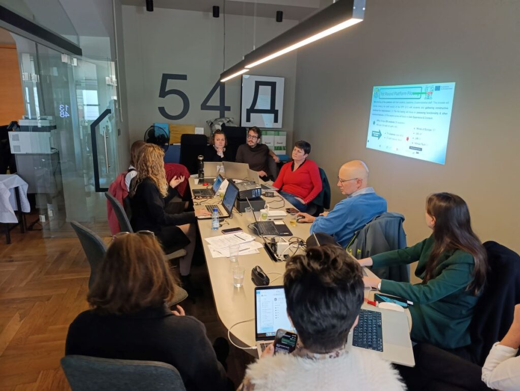 Project representatives sitting around a table and discussing
